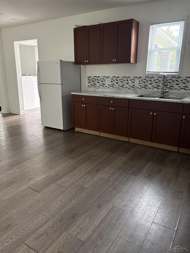 2024 Cooper Ave, Saginaw, MI 48602 - kitchen with freestanding refrigerator, dark wood-style flooring, tasteful backsplash, and light countertops