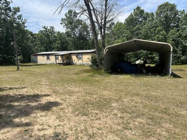 3245 W Leisura Loop, Baldwin, MI 49304 - view of front facade featuring a front yard and a carport