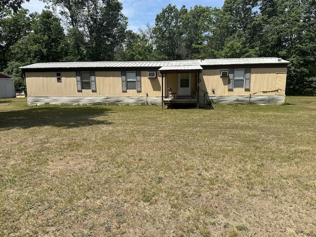 3245 W Leisura Loop, Baldwin, MI 49304 - view of front of home featuring a front lawn, a metal roof, and view of wooded area