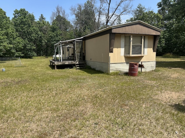 3245 W Leisura Loop, Baldwin, MI 49304 - view of home's exterior with a lawn
