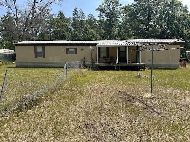 3245 W Leisura Loop, Baldwin, MI 49304 - rear view of house featuring a yard and a metal roof