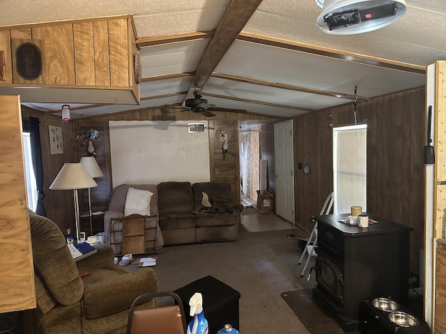 3245 W Leisura Loop, Baldwin, MI 49304 - carpeted living area with wooden walls, ceiling fan, and a wood stove
