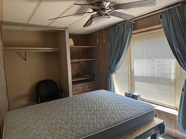 3245 W Leisura Loop, Baldwin, MI 49304 - bedroom with wood walls and ceiling fan