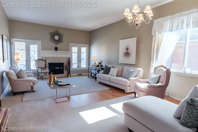 49866 Sleeping River Dr, Macomb, MI 48042 - living area with a chandelier, plenty of natural light, a tile fireplace, and wood finished floors