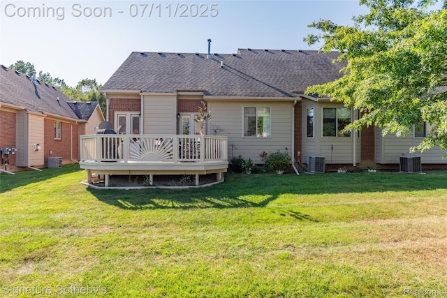 49866 Sleeping River Dr, Macomb, MI 48042 - back of property with a deck, a lawn, and a shingled roof