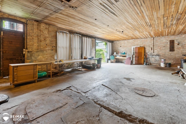 616 S Warren Ave, Saginaw, MI 48607 - miscellaneous room featuring a workshop area, wooden ceiling, plenty of natural light, concrete flooring, and brick wall