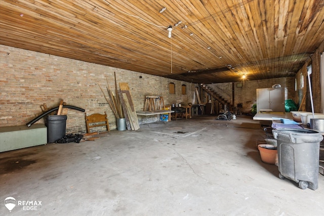 616 S Warren Ave, Saginaw, MI 48607 - misc room with unfinished concrete floors and brick wall