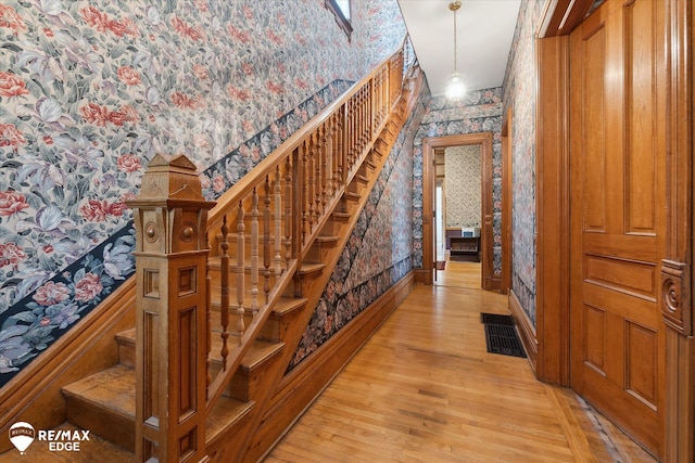 616 S Warren Ave, Saginaw, MI 48607 - stairs featuring wallpapered walls and wood-type flooring