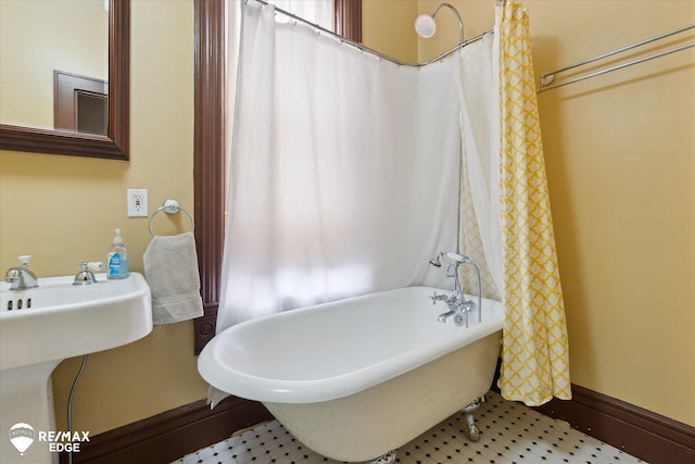 616 S Warren Ave, Saginaw, MI 48607 - bathroom with a soaking tub and a sink