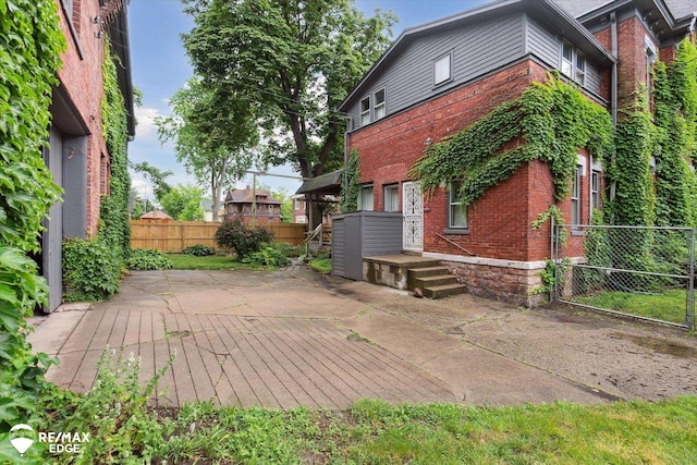 616 S Warren Ave, Saginaw, MI 48607 - view of side of home with brick siding and a patio