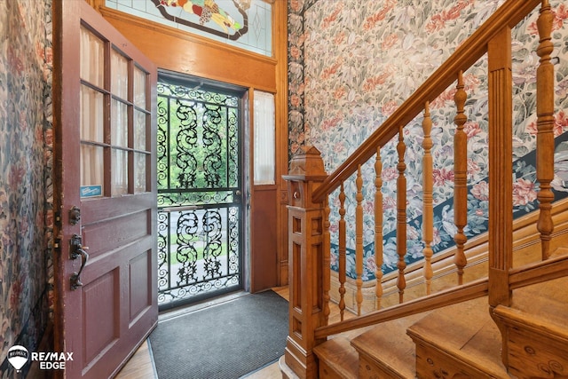 616 S Warren Ave, Saginaw, MI 48607 - foyer with wallpapered walls, wainscoting, and stairs