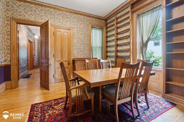 616 S Warren Ave, Saginaw, MI 48607 - dining area with wallpapered walls, ornamental molding, and light wood-style flooring