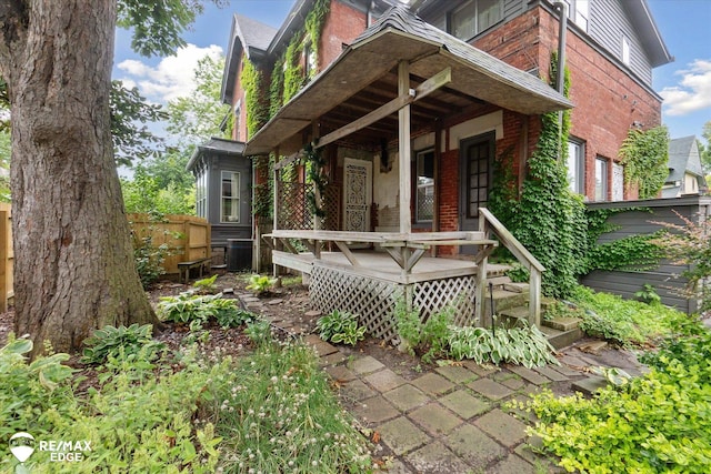 616 S Warren Ave, Saginaw, MI 48607 - view of front facade with brick siding, a garage, and a porch