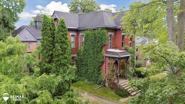 616 S Warren Ave, Saginaw, MI 48607 - view of front facade with brick siding and a chimney