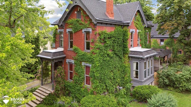 616 S Warren Ave, Saginaw, MI 48607 - view of property exterior with a chimney and brick siding