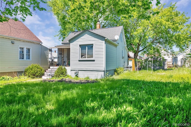 3875 Sobieski St, Hamtramck, MI 48212 - view of front of home with a chimney and a shingled roof