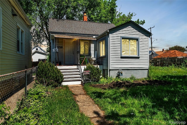 3875 Sobieski St, Hamtramck, MI 48212 - bungalow-style house with roof with shingles, a chimney, and a porch