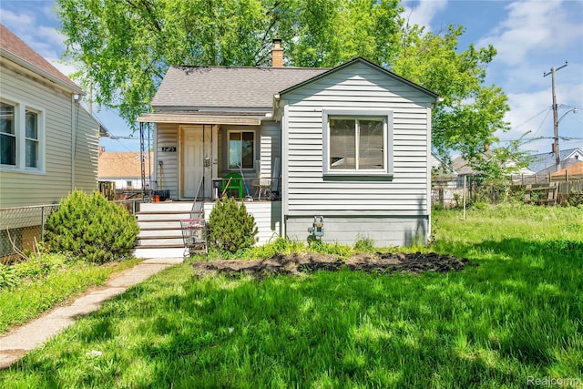 3875 Sobieski St, Hamtramck, MI 48212 - view of front facade featuring a chimney and a shingled roof