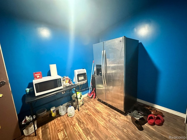 3875 Sobieski St, Hamtramck, MI 48212 - kitchen featuring white microwave, stainless steel refrigerator with ice dispenser, heating unit, and wood finished floors