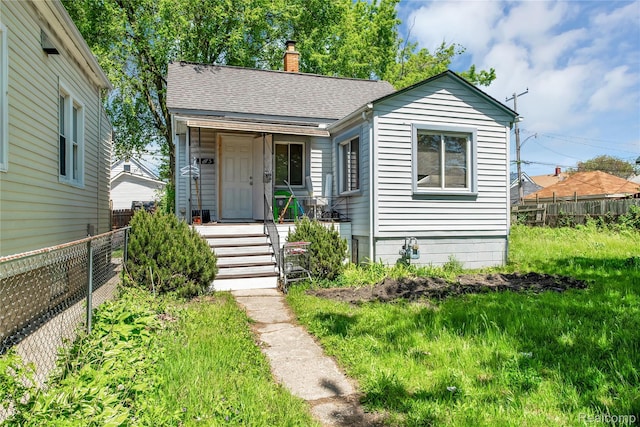 3875 Sobieski St, Hamtramck, MI 48212 - view of front of property featuring a chimney and a shingled roof