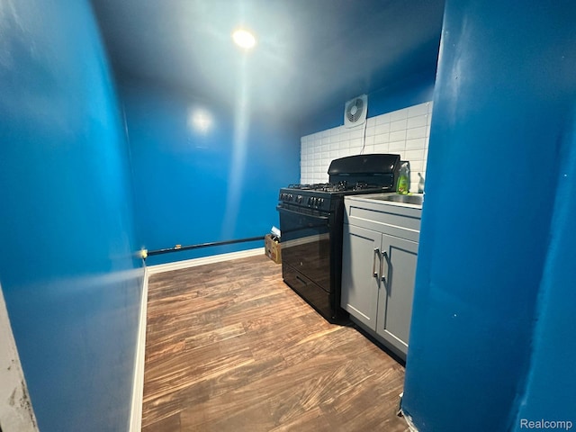 3875 Sobieski St, Hamtramck, MI 48212 - kitchen with black gas stove, backsplash, and wood finished floors