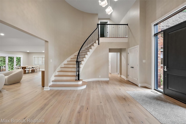 3546 Bloomfield Club Dr, Bloomfield Hills, MI 48301 - foyer entrance featuring high vaulted ceiling, stairs, and wood finished floors
