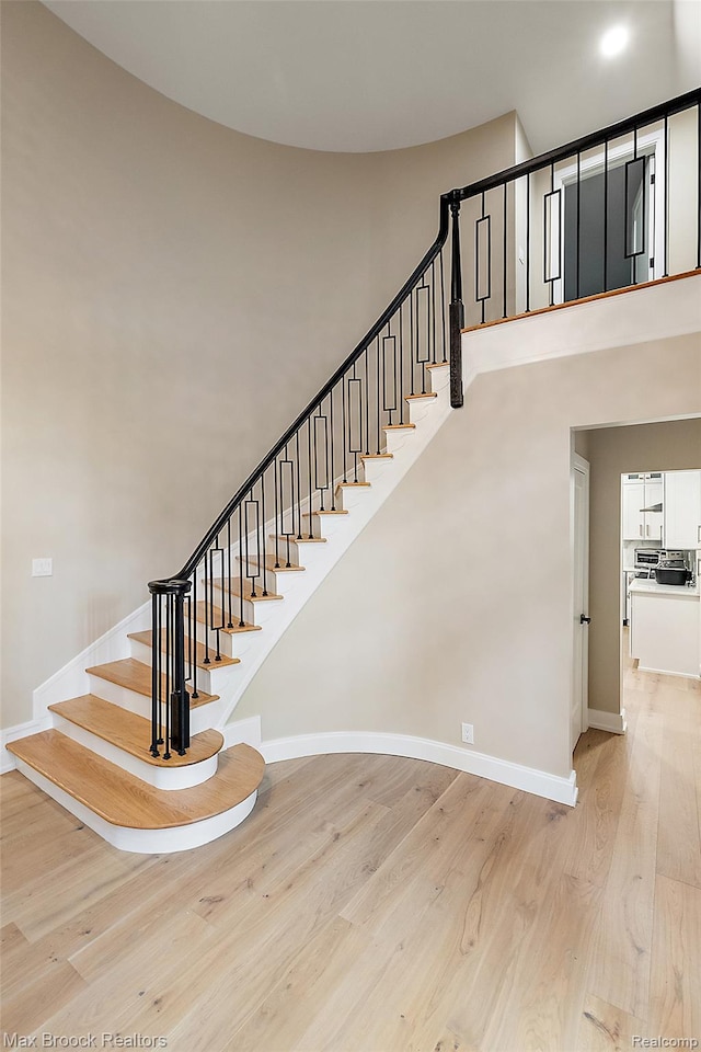 3546 Bloomfield Club Dr, Bloomfield Hills, MI 48301 - stairway featuring wood finished floors and a towering ceiling