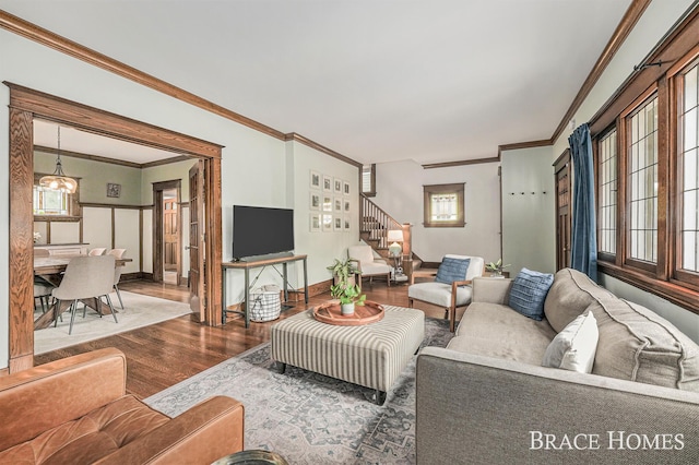 1035 Fountain St NE, Grand Rapids, MI 49503 - living room featuring wood finished floors, stairs, and ornamental molding