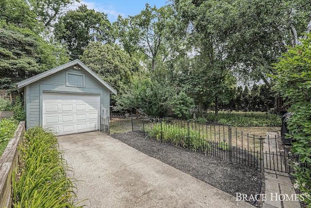 1035 Fountain St NE, Grand Rapids, MI 49503 - detached garage with driveway and view of scattered trees
