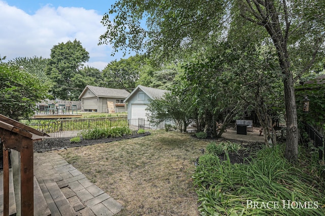 1035 Fountain St NE, Grand Rapids, MI 49503 - view of yard featuring a detached garage, a patio area, and an outbuilding