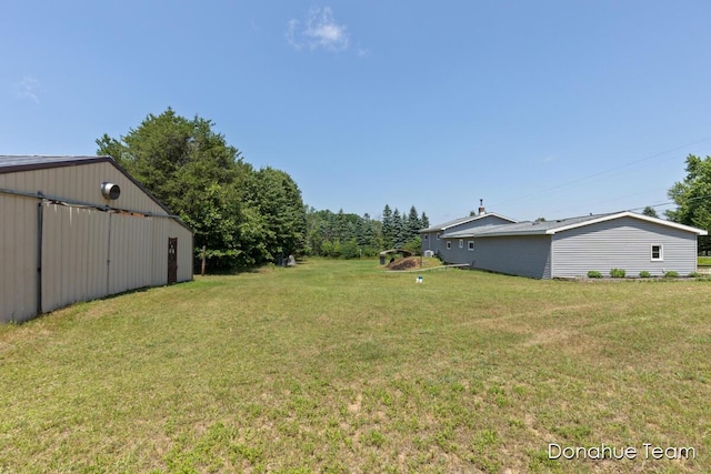 4875 Ferris Ave, Newaygo, MI 49337 - view of green lawn with a pole building and an outbuilding