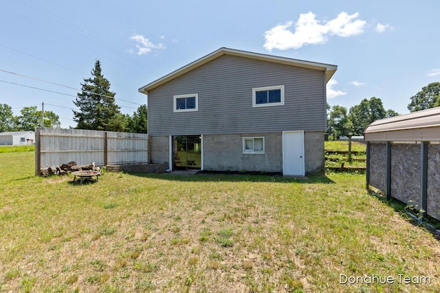 4875 Ferris Ave, Newaygo, MI 49337 - rear view of house with an outdoor fire pit
