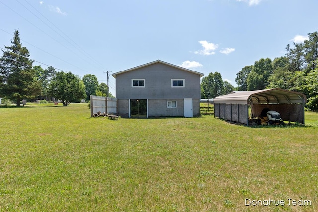 4875 Ferris Ave, Newaygo, MI 49337 - rear view of house with a detached carport and a lawn