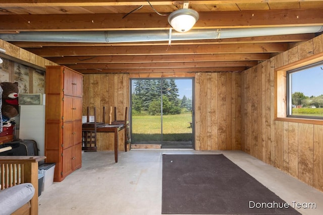 4875 Ferris Ave, Newaygo, MI 49337 - miscellaneous room with concrete flooring, healthy amount of natural light, and wooden walls