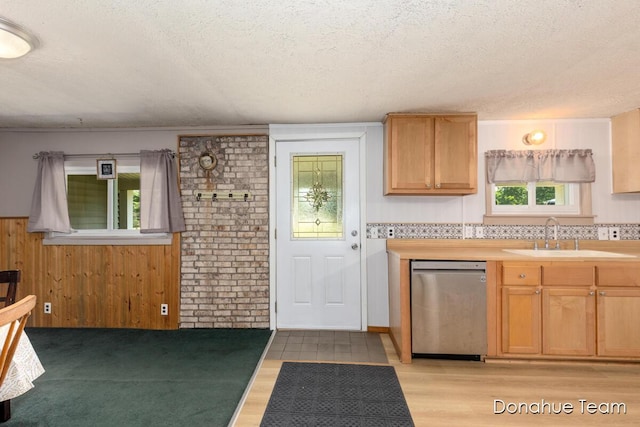 4875 Ferris Ave, Newaygo, MI 49337 - kitchen featuring dishwasher, a textured ceiling, light wood-style flooring, light countertops, and wood walls