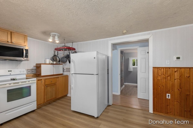 4875 Ferris Ave, Newaygo, MI 49337 - kitchen with white appliances, a textured ceiling, light wood-type flooring, crown molding, and wooden walls