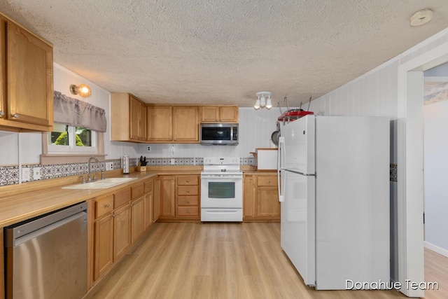 4875 Ferris Ave, Newaygo, MI 49337 - kitchen featuring stainless steel appliances, a textured ceiling, light wood finished floors, and light countertops