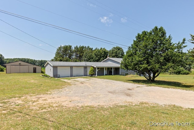4875 Ferris Ave, Newaygo, MI 49337 - ranch-style house featuring driveway, a front yard, and a garage