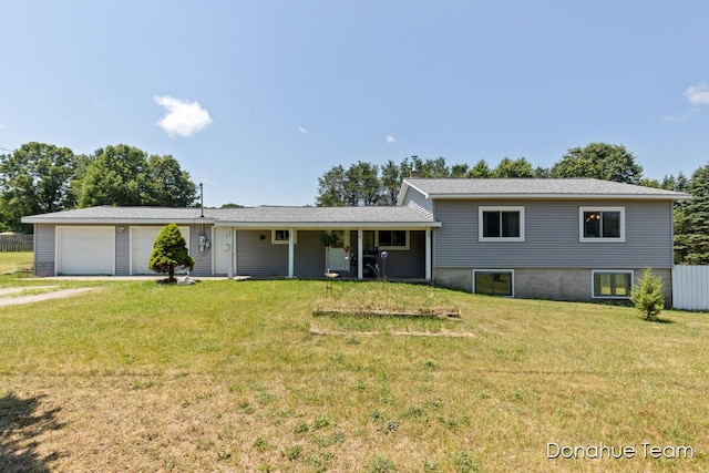 4875 Ferris Ave, Newaygo, MI 49337 - tri-level home with a front lawn, an attached garage, and driveway