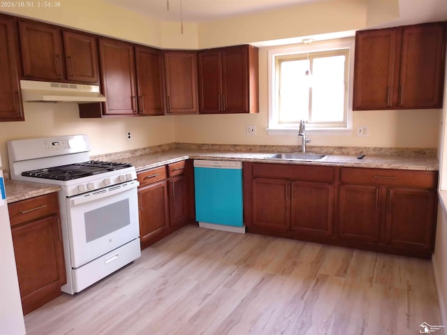 27354 Oakcrest Dr, Brownstown, MI 48183 - kitchen featuring white gas range, under cabinet range hood, dishwashing machine, light wood-style floors, and light countertops
