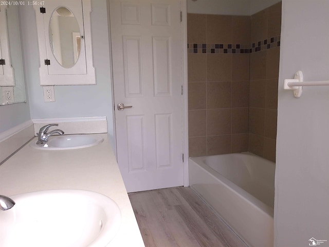 27354 Oakcrest Dr, Brownstown, MI 48183 - bathroom with double vanity, tub / shower combination, and wood finished floors
