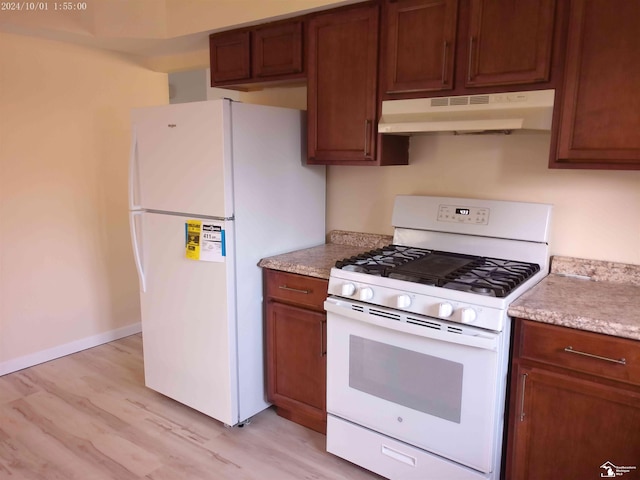 27354 Oakcrest Dr, Brownstown, MI 48183 - kitchen with white appliances, under cabinet range hood, light wood-type flooring, and light countertops