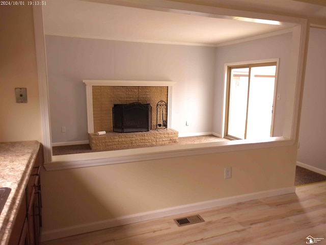 27354 Oakcrest Dr, Brownstown, MI 48183 - unfurnished living room featuring crown molding, a fireplace, and wood finished floors