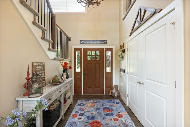 12529 E Tuscola Rd, Frankenmuth, MI 48734 - entrance foyer with a chandelier, dark wood-style floors, a towering ceiling, and stairway