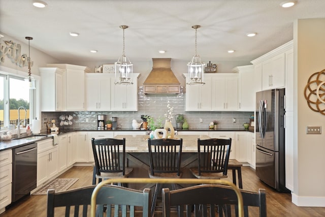 12529 E Tuscola Rd, Frankenmuth, MI 48734 - kitchen featuring stainless steel appliances, custom range hood, a kitchen bar, a center island, and white cabinets