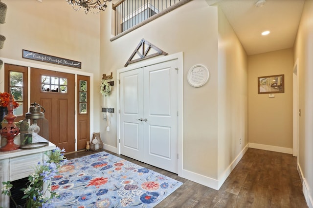12529 E Tuscola Rd, Frankenmuth, MI 48734 - foyer entrance featuring dark wood-style flooring, a high ceiling, a chandelier, and recessed lighting