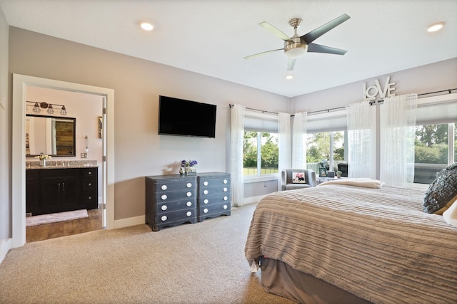 12529 E Tuscola Rd, Frankenmuth, MI 48734 - carpeted bedroom featuring multiple windows, connected bathroom, a ceiling fan, and recessed lighting