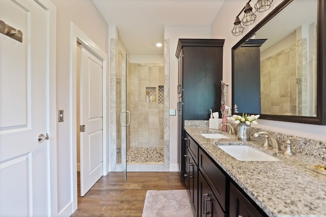 12529 E Tuscola Rd, Frankenmuth, MI 48734 - full bathroom with a stall shower, double vanity, wood finished floors, and recessed lighting