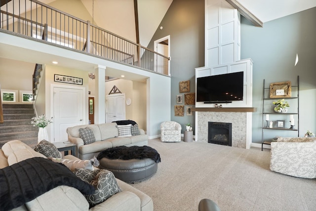 12529 E Tuscola Rd, Frankenmuth, MI 48734 - carpeted living room featuring a towering ceiling, stairway, and a glass covered fireplace