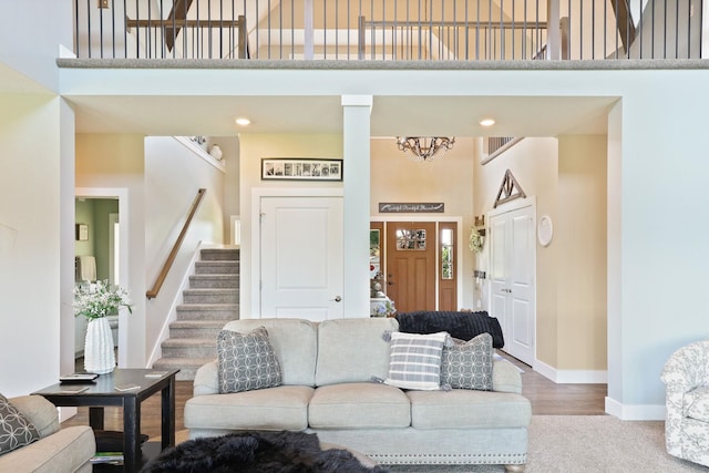 12529 E Tuscola Rd, Frankenmuth, MI 48734 - living room featuring a high ceiling, stairway, carpet, and a chandelier